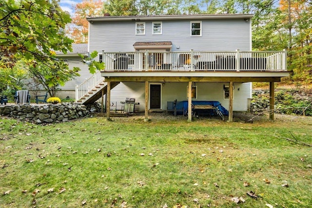 back of property with stairway, a lawn, and a wooden deck