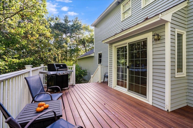 wooden terrace featuring a grill