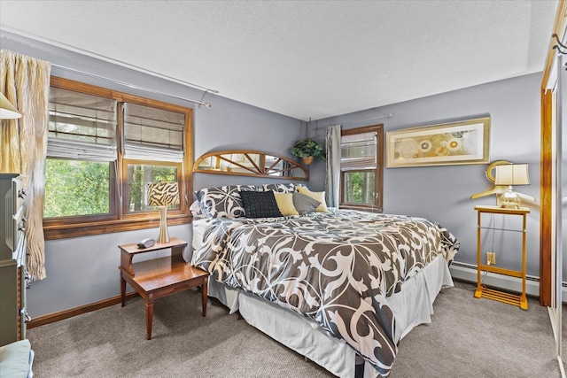 carpeted bedroom with a textured ceiling, multiple windows, baseboard heating, and baseboards