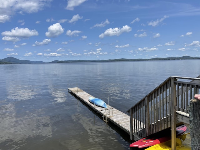 view of dock with a water and mountain view