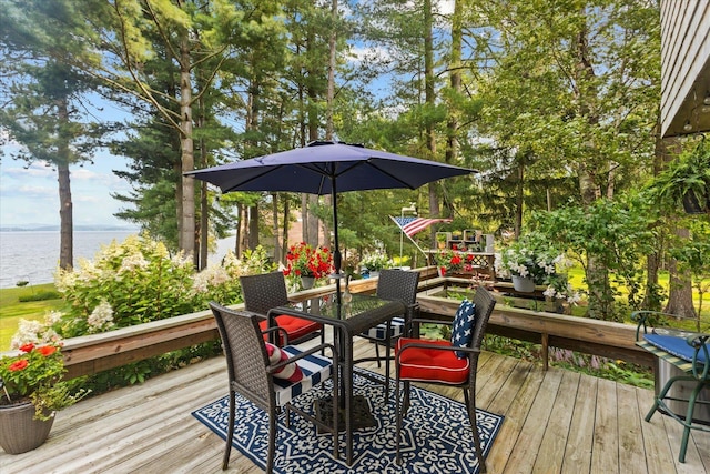 deck featuring a water view and outdoor dining space