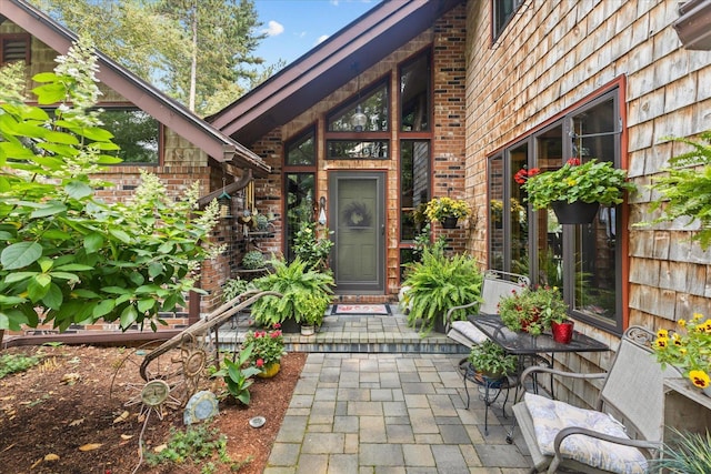 view of exterior entry with brick siding