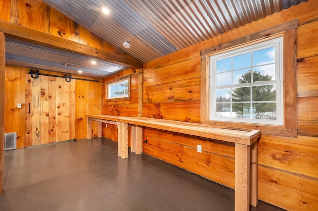 interior space with wooden walls, visible vents, a sauna, wood ceiling, and vaulted ceiling