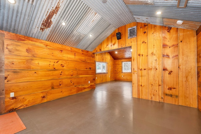 additional living space with lofted ceiling, wooden ceiling, and wooden walls