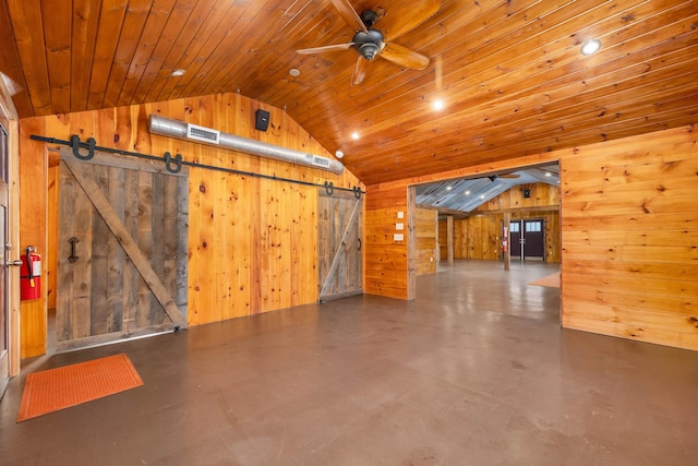 bonus room with ceiling fan, a barn door, wooden ceiling, wood walls, and vaulted ceiling