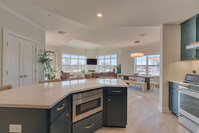 kitchen with recessed lighting, stainless steel appliances, visible vents, light wood-style floors, and light countertops