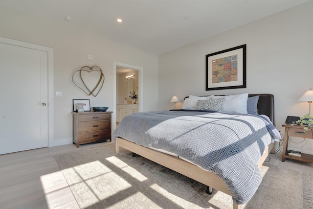 bedroom with recessed lighting, baseboards, ensuite bath, and light wood finished floors