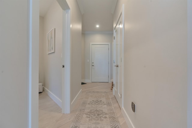 hall with ornamental molding, light wood finished floors, recessed lighting, and baseboards