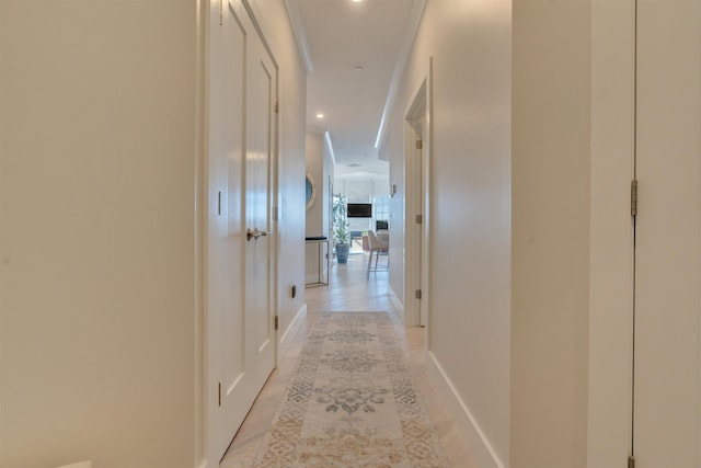 hall with recessed lighting and baseboards