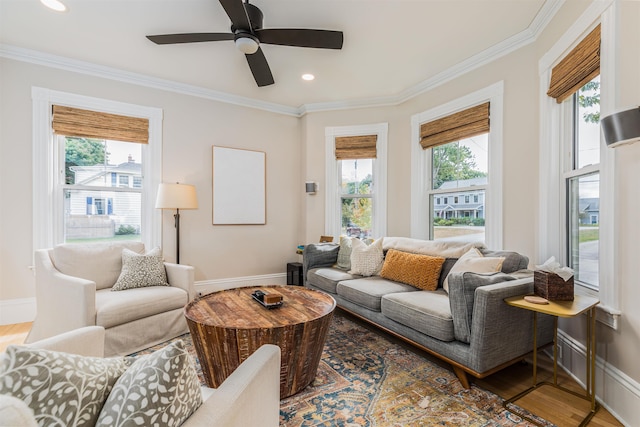 living room featuring plenty of natural light, crown molding, and wood finished floors