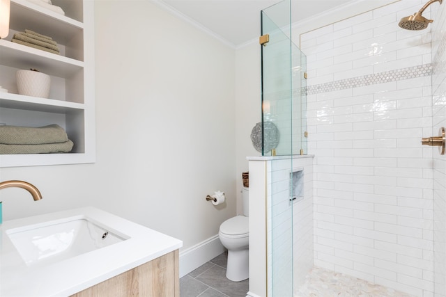 bathroom featuring toilet, a sink, baseboards, a stall shower, and crown molding