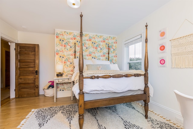 bedroom featuring baseboards and wood finished floors