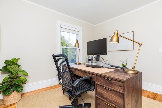 office space featuring baseboards, ornamental molding, and wood finished floors