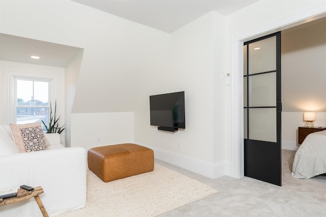 living area featuring carpet flooring and baseboards