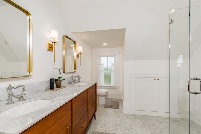 full bath featuring toilet, a shower stall, double vanity, and a sink