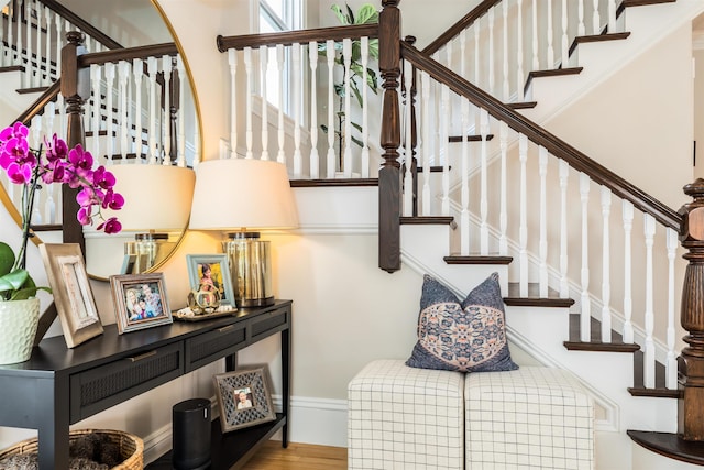 stairway with baseboards and wood finished floors