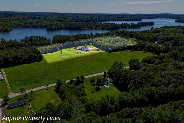 birds eye view of property featuring a forest view and a water view