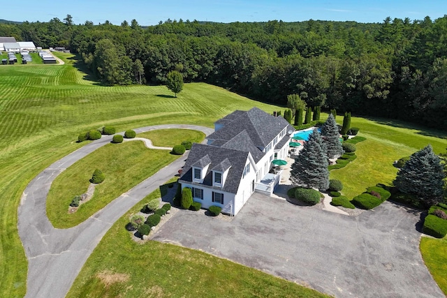 birds eye view of property with a wooded view