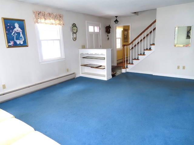 interior space with a baseboard heating unit, stairway, and carpet flooring