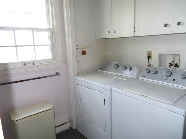 laundry area featuring a baseboard radiator, washing machine and clothes dryer, and cabinet space