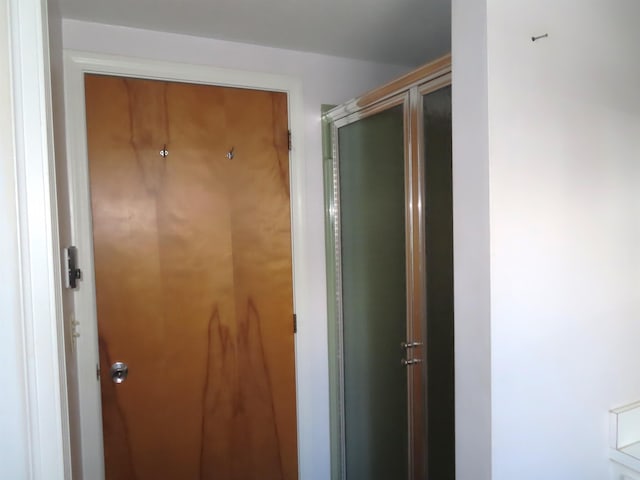 bathroom featuring a shower with door