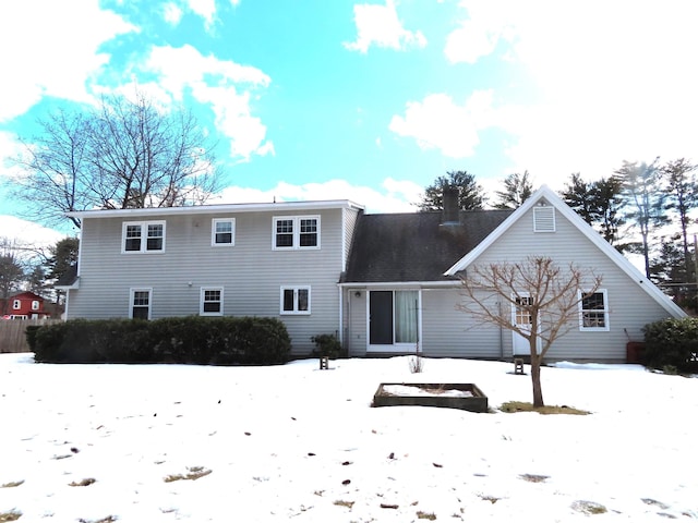 view of snow covered back of property