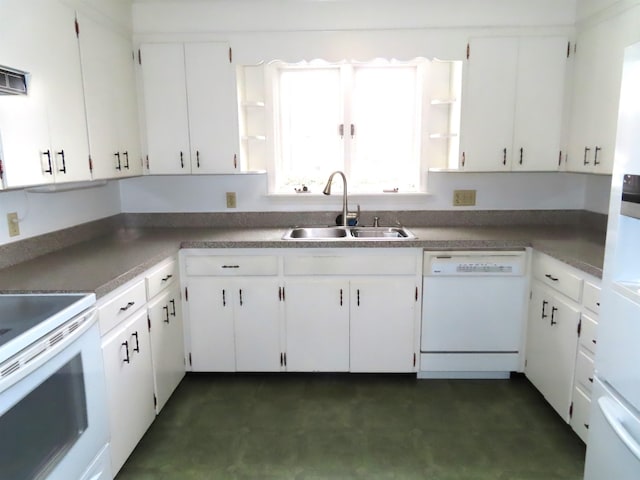 kitchen with white appliances, a sink, and white cabinets