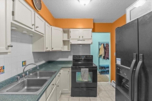 kitchen with white cabinets, a baseboard radiator, under cabinet range hood, black appliances, and a sink