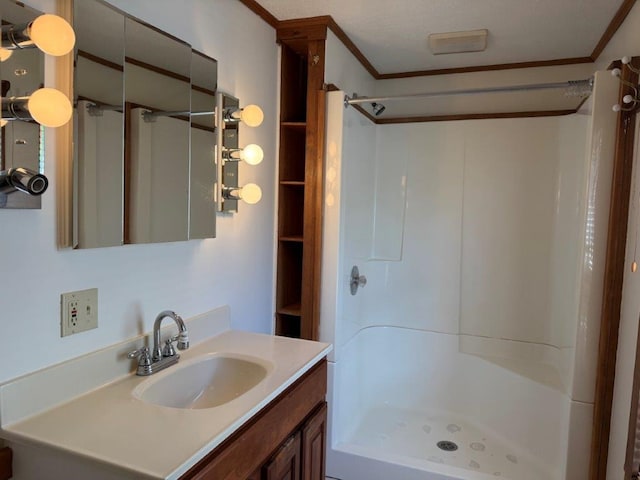 bathroom featuring ornamental molding, a stall shower, and vanity