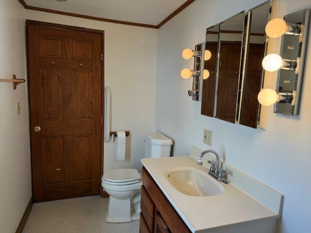 bathroom featuring vanity, toilet, and crown molding