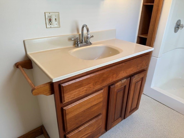 full bath featuring walk in shower and vanity