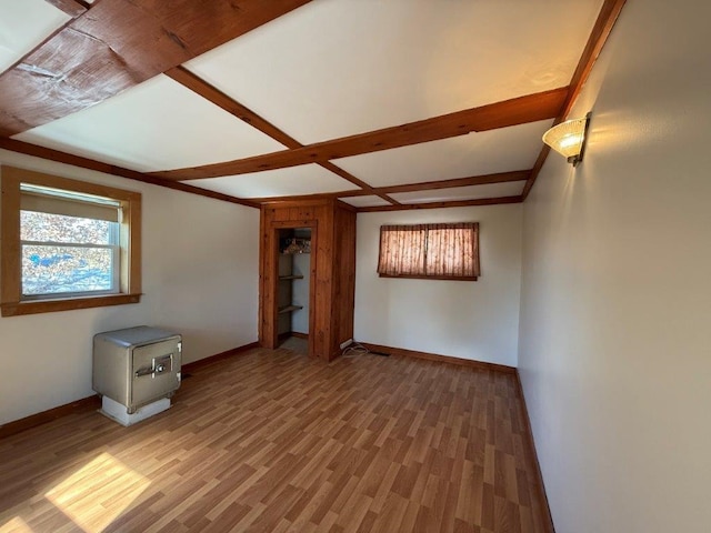 unfurnished room with light wood finished floors and baseboards