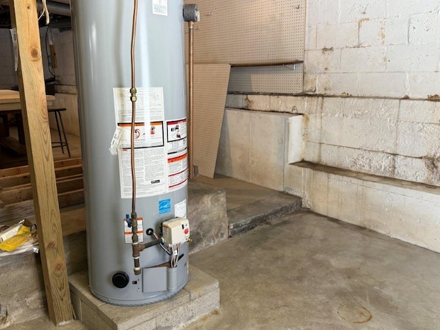 utility room featuring water heater