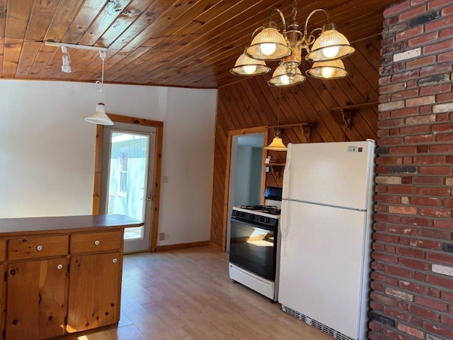 kitchen with wood walls, wood ceiling, light wood-style floors, freestanding refrigerator, and gas range oven