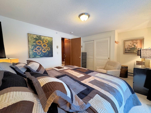 carpeted bedroom with a textured ceiling, a closet, and baseboard heating