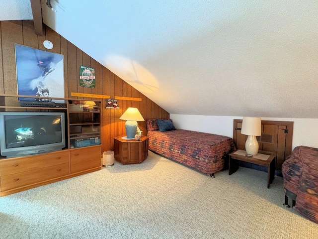 carpeted bedroom featuring lofted ceiling with beams, wooden walls, and a textured ceiling