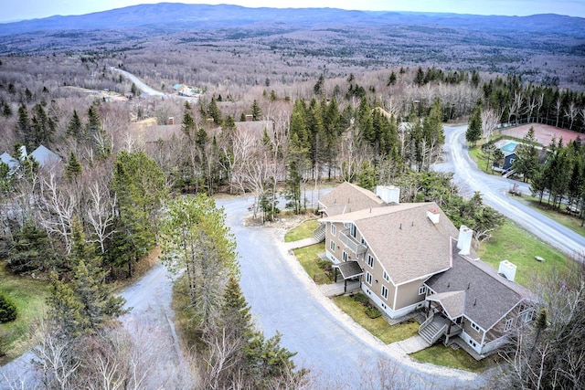 bird's eye view featuring a forest view and a mountain view