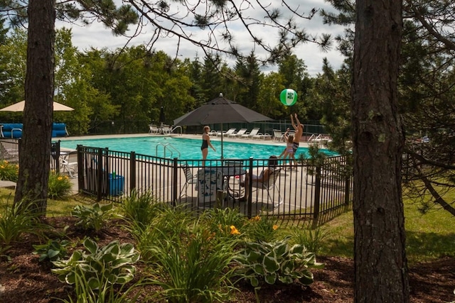 pool with a patio area and fence