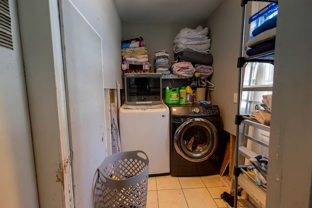 laundry room featuring tile patterned floors, laundry area, and washing machine and dryer