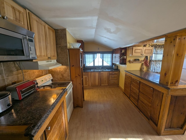 kitchen featuring electric stove, light wood finished floors, lofted ceiling, stainless steel microwave, and a sink