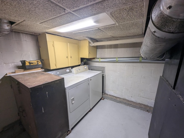 washroom featuring independent washer and dryer and cabinet space