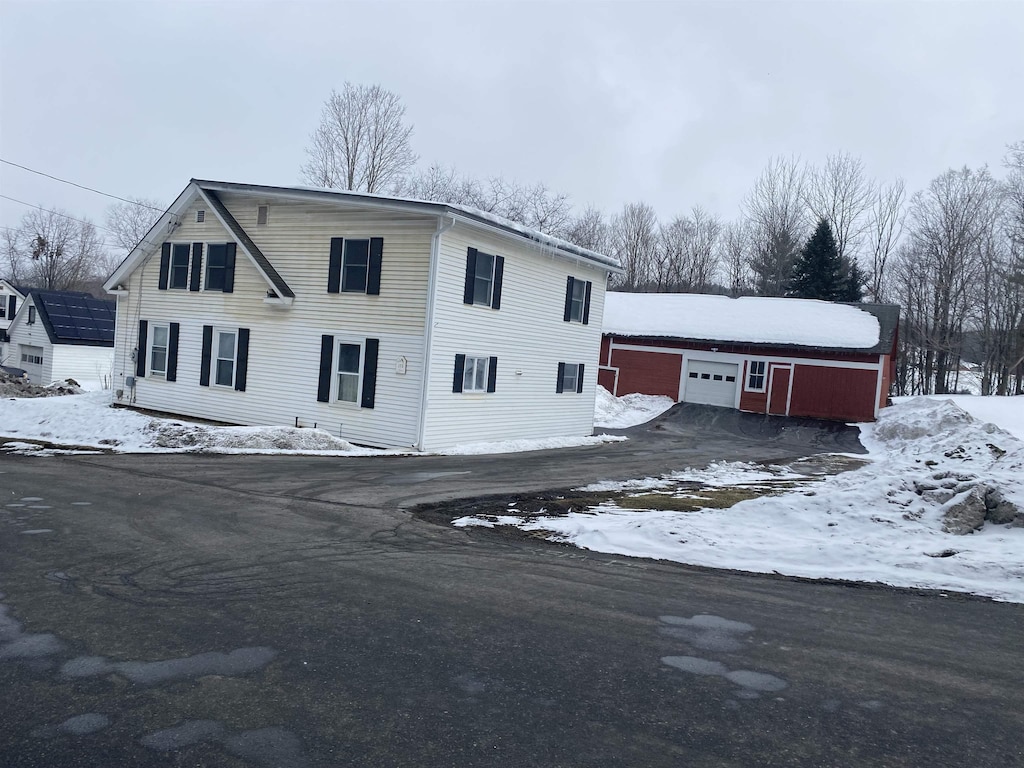 view of front of home with a garage and an outdoor structure