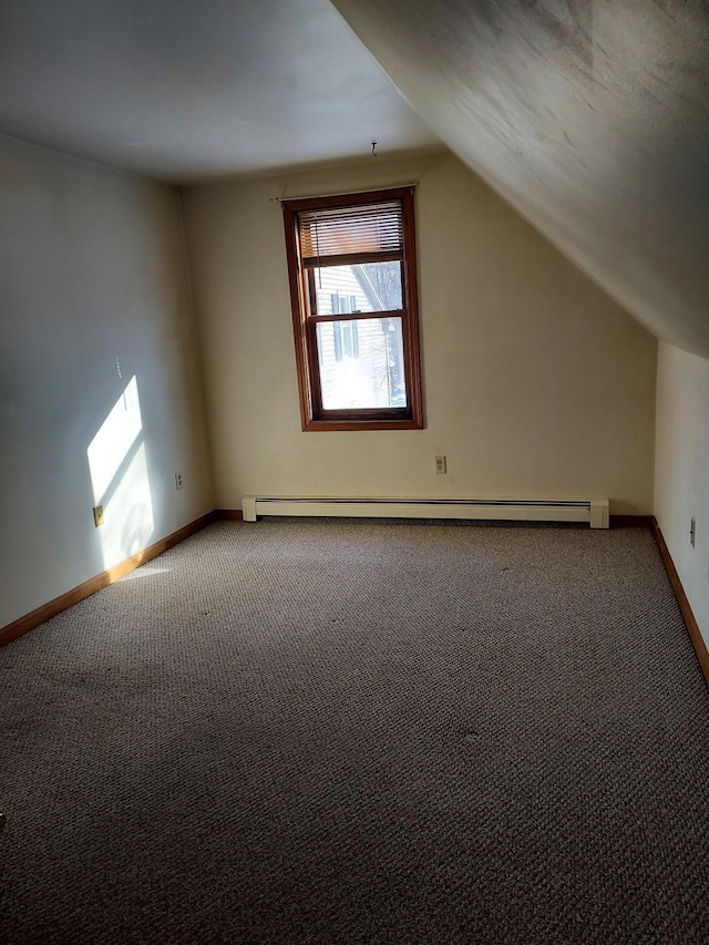 bonus room featuring baseboards, a baseboard heating unit, vaulted ceiling, and carpet flooring