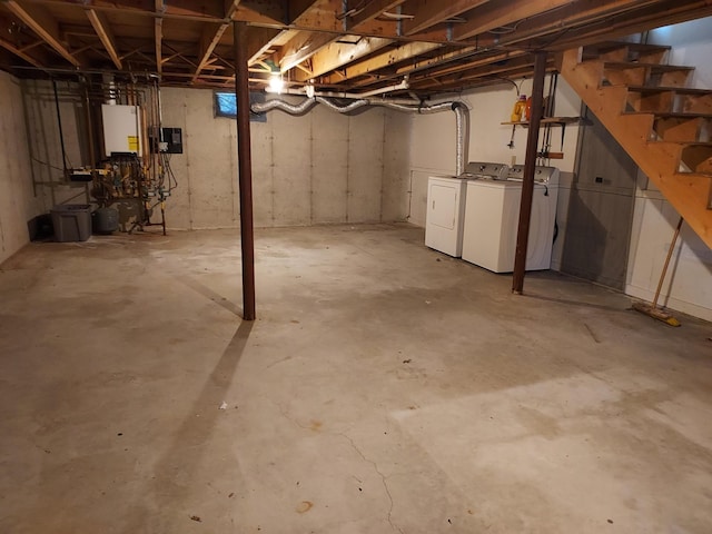 unfinished basement with stairway, water heater, and washer and clothes dryer