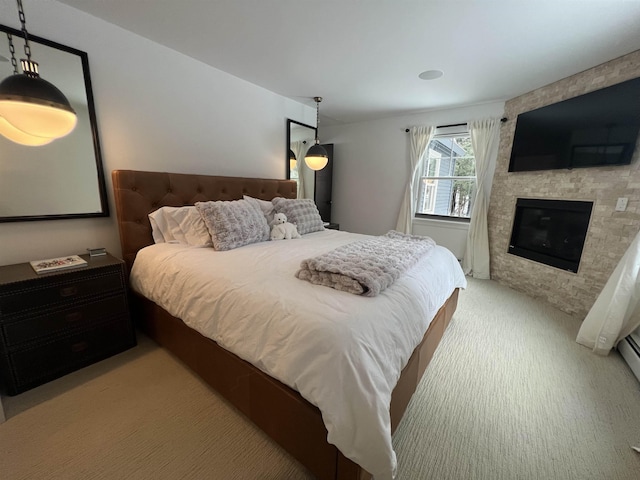 carpeted bedroom with a large fireplace