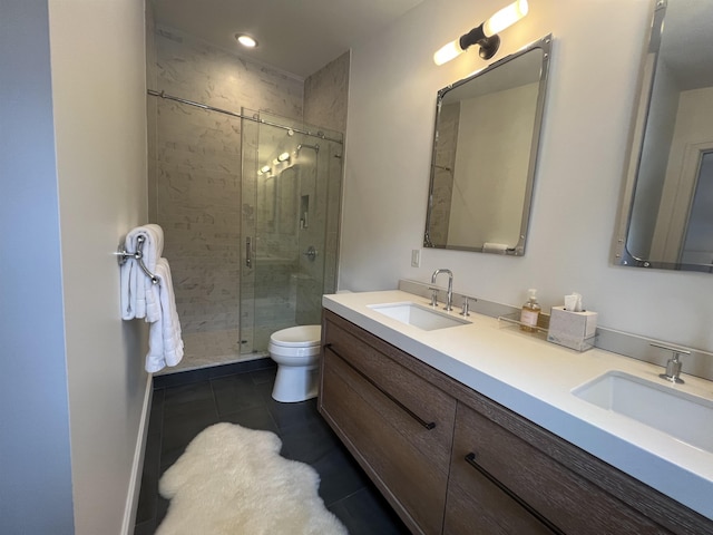 bathroom featuring a sink, a stall shower, double vanity, and tile patterned flooring