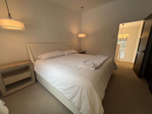 carpeted bedroom featuring a notable chandelier