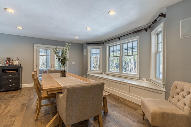 dining room with hardwood / wood-style flooring and recessed lighting