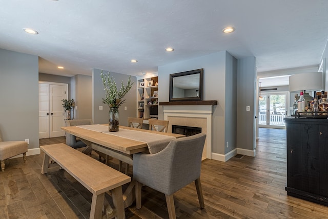 dining area featuring recessed lighting, baseboards, a fireplace, and hardwood / wood-style floors