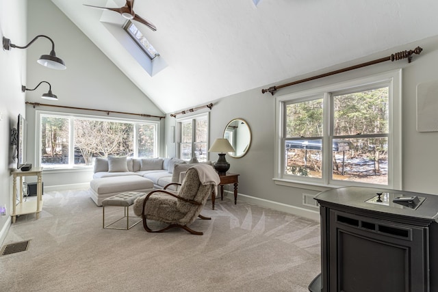 bedroom with baseboards, a skylight, visible vents, and light colored carpet